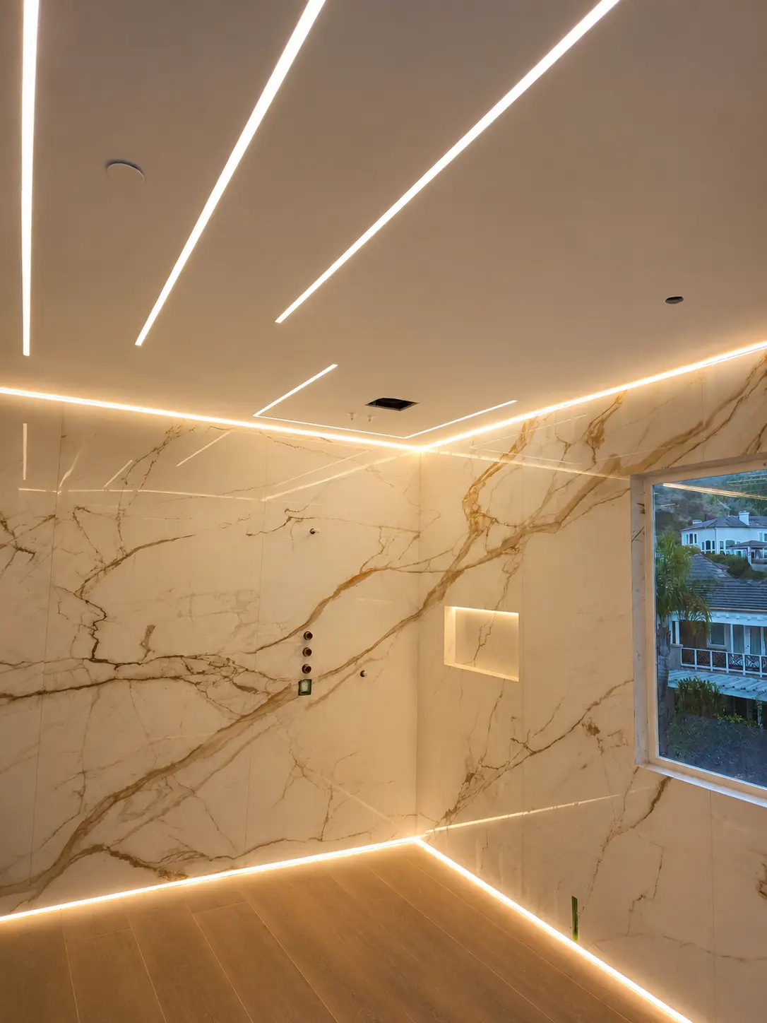 Marble bathroom with bright linear ceiling and perimeter LED lighting