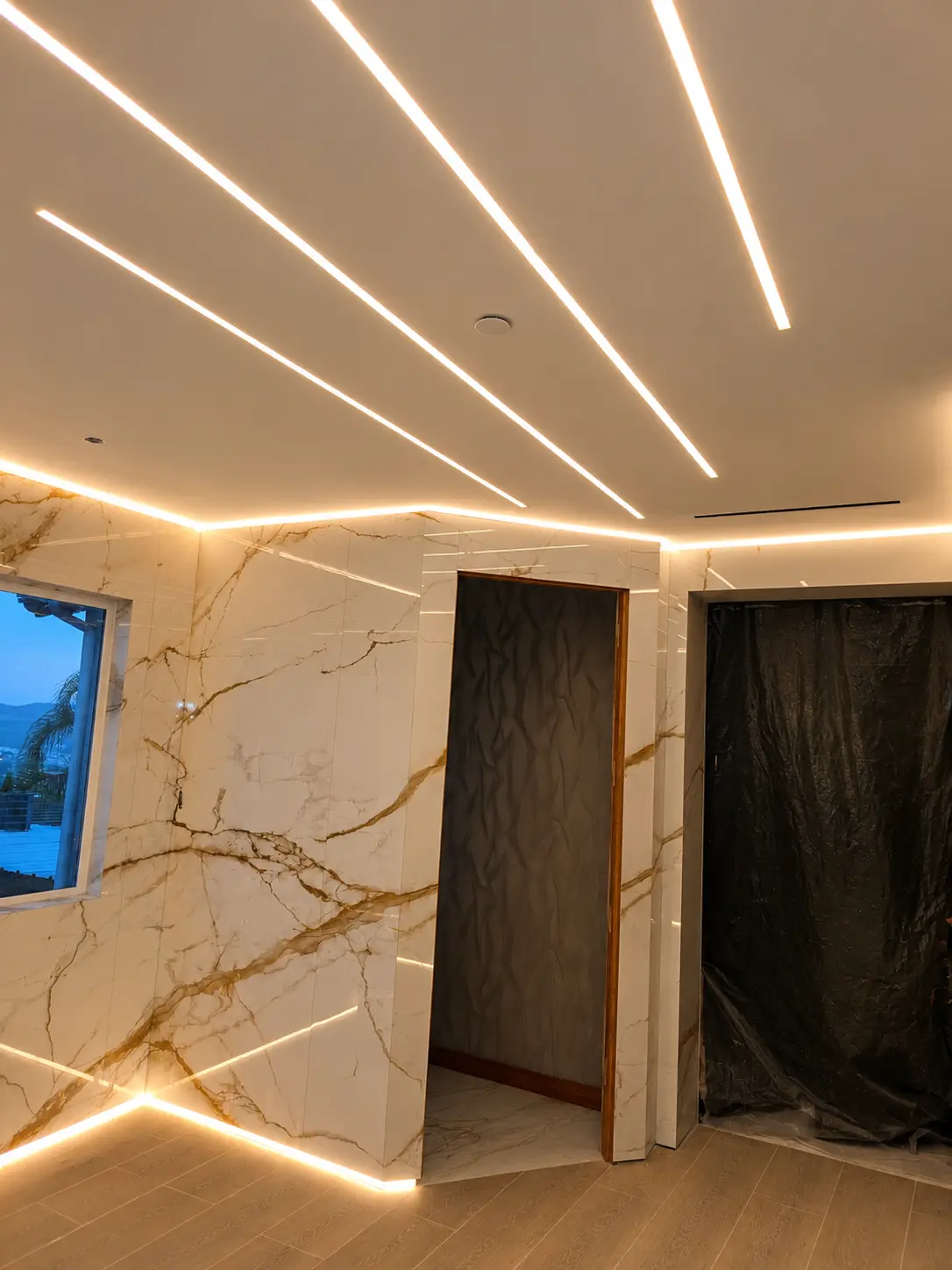 Marble bathroom with warm perimeter lighting for the night scene