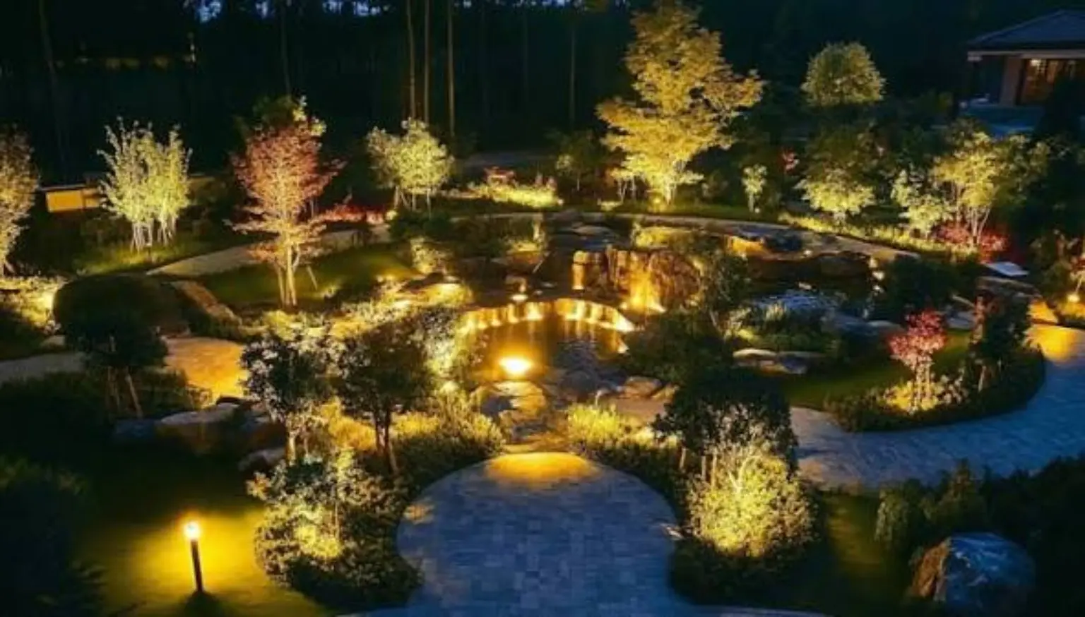 Wide view of a landscaped garden illuminated at night in Los Angeles