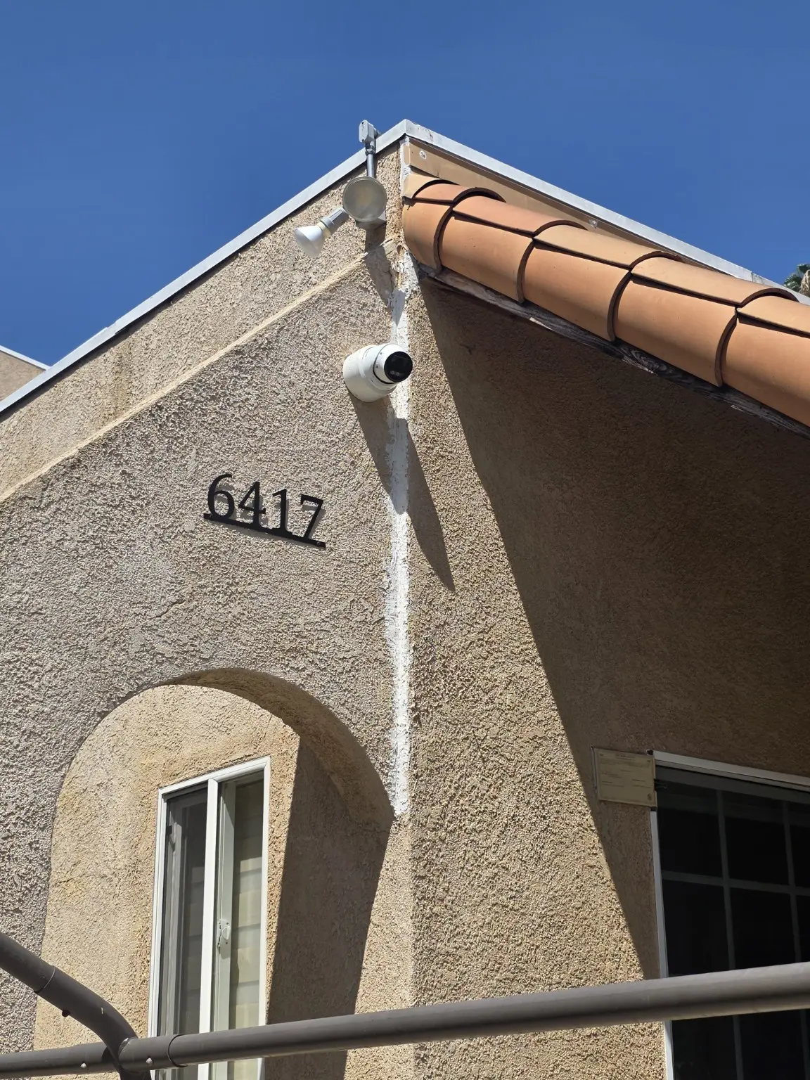 Exterior security camera installed above the front entrance of a Pasadena property
