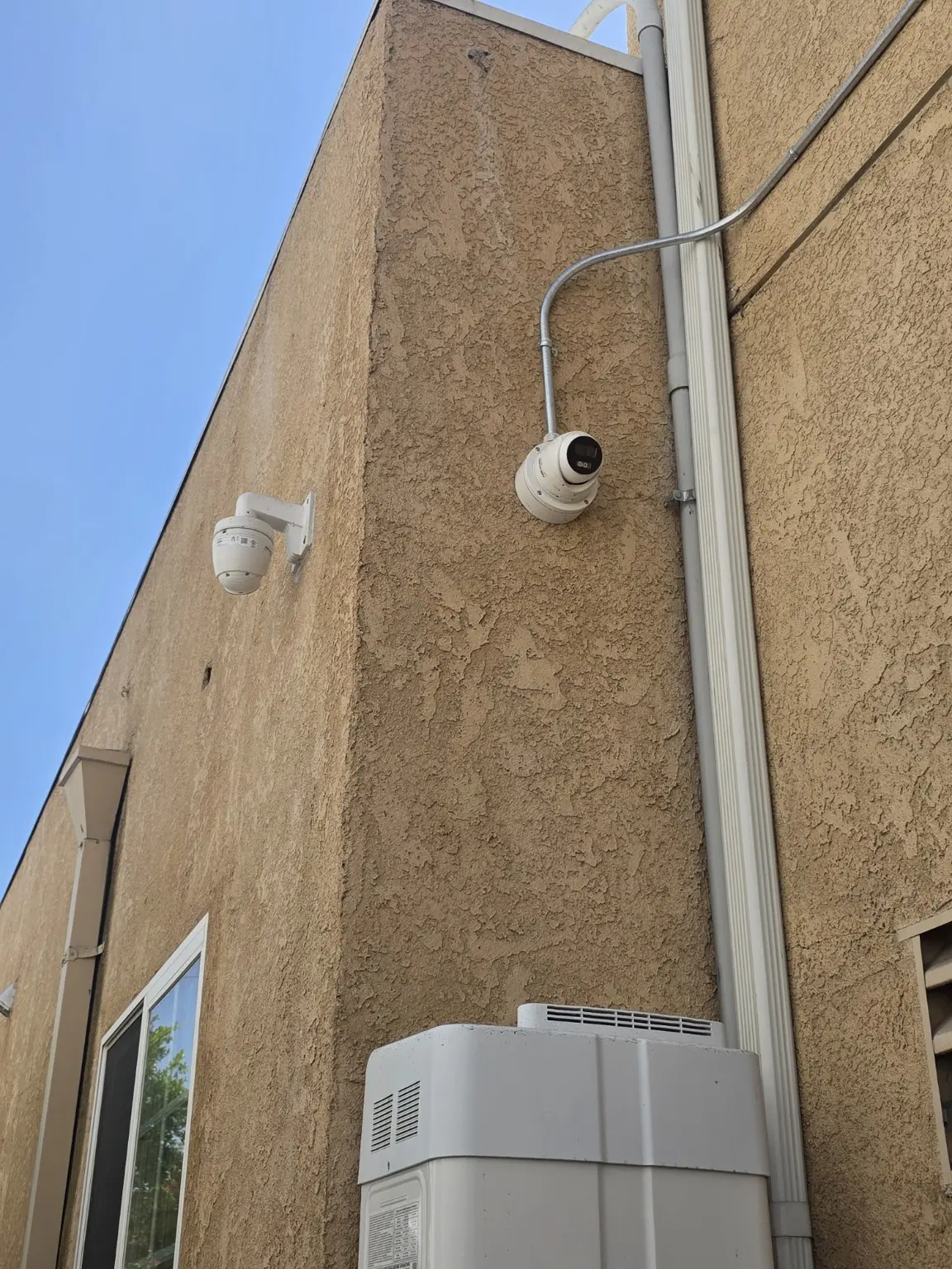 Exterior security camera mounted beside a protected cable route in Pasadena