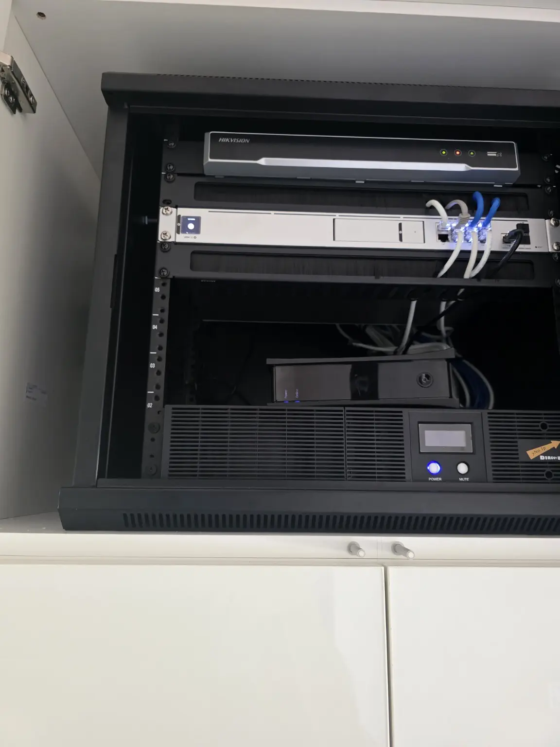 Central rack with Hikvision recorder and network equipment in Studio City
