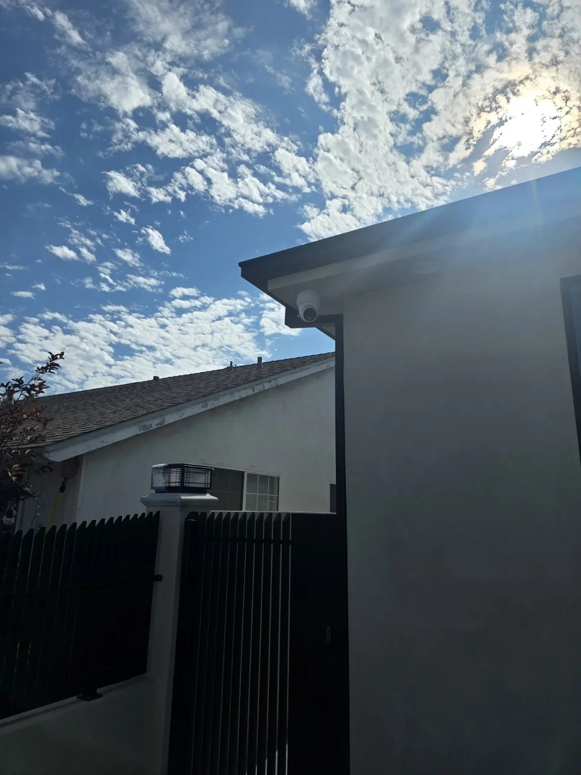 Exterior security camera positioned above a side gate in Studio City