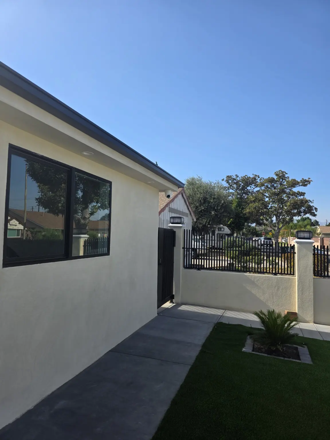 Studio City home with exterior security camera coverage near the pedestrian gate
